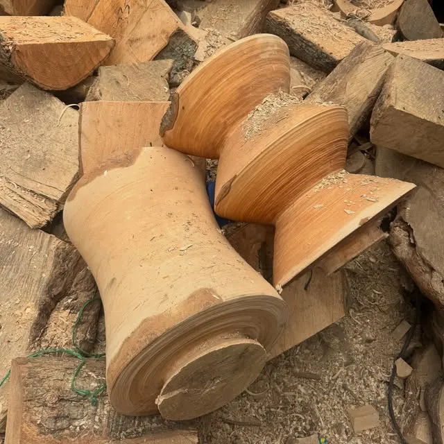 Turned timber legs and offcuts in the workshop yard.
